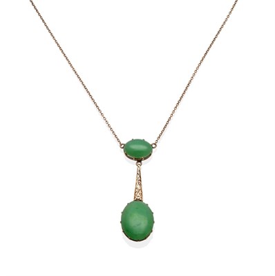 Lot 2018 - A Jade Necklace, an oval cabochon jade in a yellow claw setting suspends a larger oval cabochon...