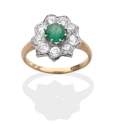 Lot 2019 - An Emerald and Diamond Cluster Ring, a round cut emerald in a white claw setting, within a...