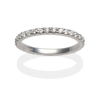 Lot 2026 - A Platinum Diamond Eternity Ring, round brilliant cut diamonds in white claw settings, on a...