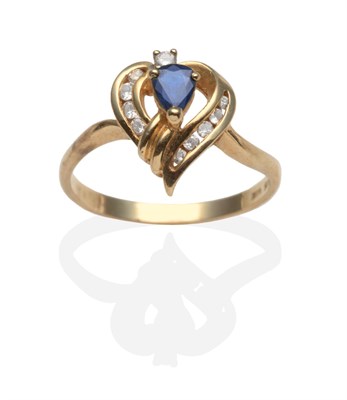 Lot 2039 - A Sapphire and Diamond Ring, a pear cut sapphire in a yellow claw setting within a scroll...