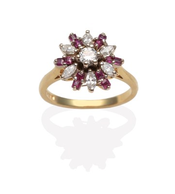 Lot 2048 - An 18 Carat Gold Ruby and Diamond Cluster Ring, a round brilliant cut diamond within a border...