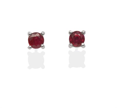 Lot 2049 - A Pair of 18 Carat White Gold Ruby Solitaire Earrings, the round cut rubies in white claw settings