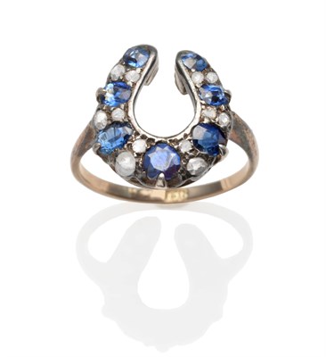 Lot 2077 - A Sapphire and Diamond Horseshoe Ring, round and oval cut sapphires spaced by pairs of rose cut...