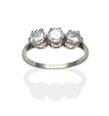 Lot 2079 - A Diamond Three Stone Ring, round brilliant cut diamonds in white claw settings, on a plain...