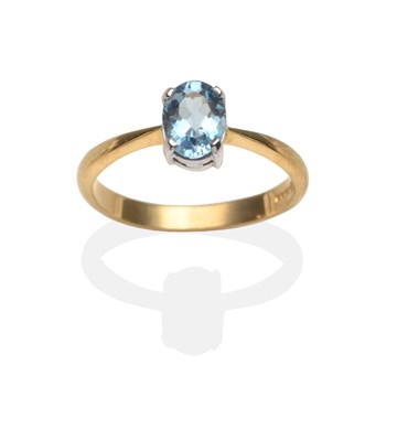 Lot 2084 - An 18 Carat Gold Aquamarine Ring, an oval cut aquamarine in a white four claw setting, to...