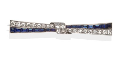 Lot 2090 - A Sapphire and Diamond Bow Brooch, a row of calibré cut cut sapphires and a row of round brilliant