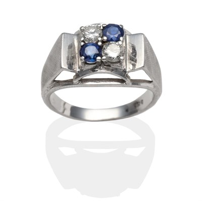 Lot 2102 - A Sapphire and Diamond Ring, two round brilliant cut diamonds and two round cut sapphires in...