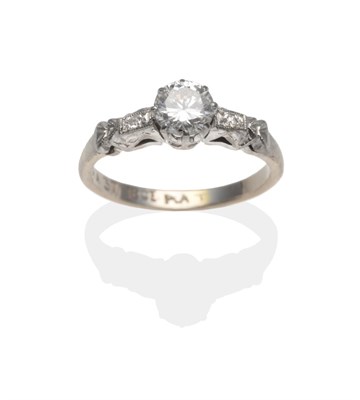 Lot 2104 - A Diamond Solitaire Ring, a round brilliant cut diamond in a white claw setting to fancy...