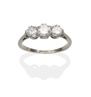 Lot 2105 - A Diamond Three Stone Ring, graduated round brilliant cut diamonds in white claw settings, to knife