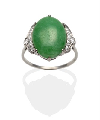 Lot 2110 - An Art Deco Jade and Diamond Ring, an oval cabochon jade in a white claw setting, to pierced...