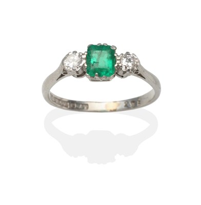 Lot 2121 - An Emerald and Diamond Three Stone Ring, an emerald-cut emerald between two old cut diamonds in...