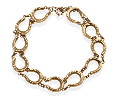 Lot 2148 - A 9 Carat Gold Horseshoe Bracelet, formed of horseshoe shaped links, length 19 cm...