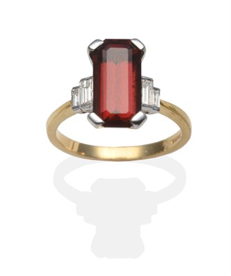 Lot 2154 - An 18 Carat Gold Garnet and Diamond Ring, an emerald-cut garnet in a white four claw setting,...