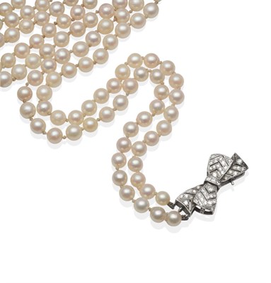 Lot 2156 - A Double Strand Cultured Pearl Necklace with Diamond Bow Clasp, two strands of 68:73 uniform...