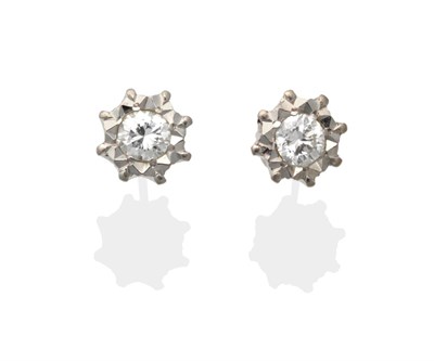 Lot 2158 - A Pair of Diamond Solitaire Earrings, a round brilliant cut diamond in a white illusion...