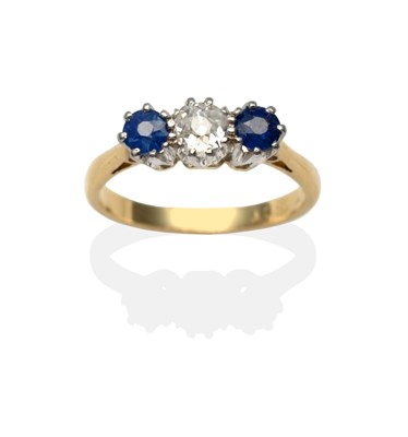 Lot 2162 - A Diamond and Sapphire Three Stone Ring, an old cut diamond between two round cut sapphires in...