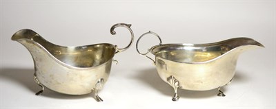 Lot 2242 - A George VI Silver Sauceboat, ES Barnsley, Birmingham 1938, with flying scroll handle and three...