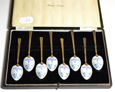 Lot 2248 - A Set of Eight Enamelled Silver Gilt Coffee Spoons, Birmingham 1956, decorated with ribbon tied...