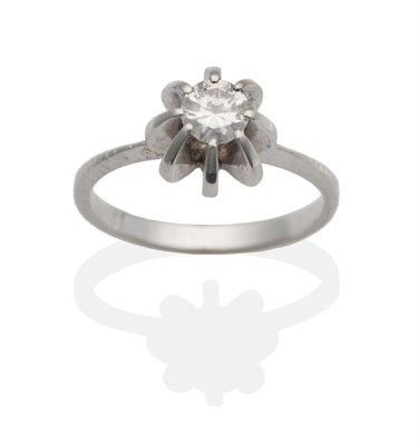 Lot 2011 - A Diamond Solitaire Ring, a round brilliant cut diamond in a raised claw setting, to knife edge...