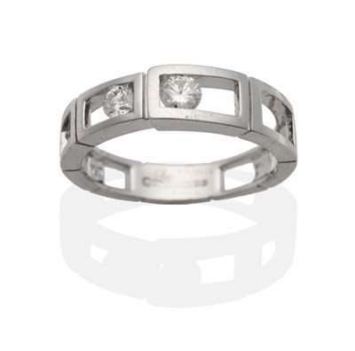 Lot 2013 - An 18 Carat White Gold Diamond Ring, a band of open rectangular links tension set with two...