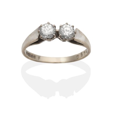 Lot 2014 - An 18 Carat White Gold Diamond Two Stone Ring, round brilliant cut diamonds in claw settings,...