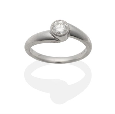 Lot 2015 - A Platinum Diamond Solitaire Ring, a round brilliant cut diamond in a rubbed over setting, to...