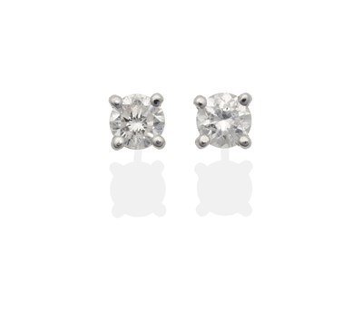 Lot 2018 - A Pair of Diamond Solitaire Earrings, a round brilliant cut diamond in a claw setting, total...