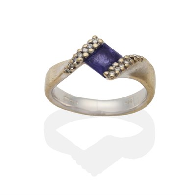 Lot 2023 - An 18 Carat White Gold Iolite and Diamond Twist Ring, a square cut iolite in a pavé set...