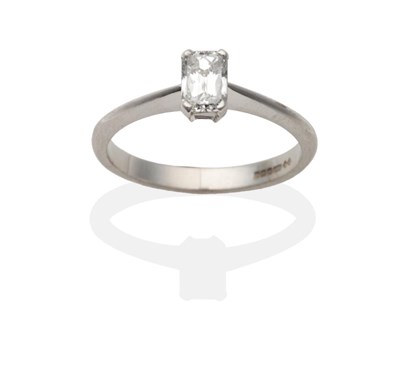 Lot 2024 - An 18 Carat White Gold Millennium Cut Diamond Solitaire Ring, in a claw setting, to knife edge...