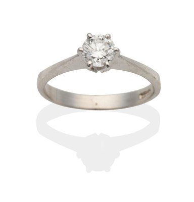 Lot 2026 - An 18 Carat White Gold Diamond Solitaire Ring, a round brilliant cut diamond in a claw setting...