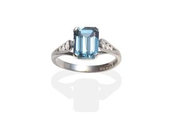 Lot 2031 - An 18 Carat White Gold Blue Topaz and Diamond Ring, an octagonal cut blue topaz in a claw...