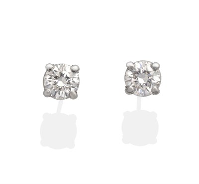 Lot 2033 - A Pair of 18 Carat White Gold Diamond Solitaire Earrings, a round brilliant cut diamond in a...