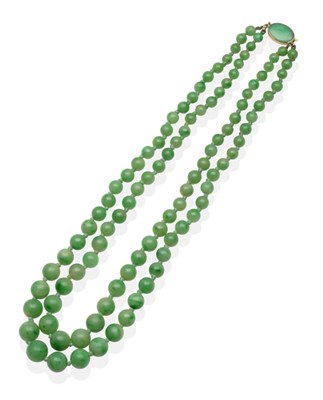 Lot 2054 - A Jade Necklace, a double strand of graduated jade beads knotted to a jade set oval clasp, shortest