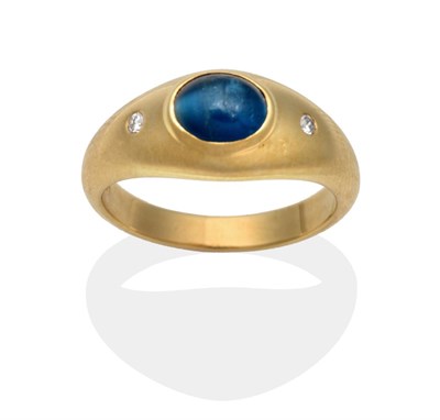 Lot 2056 - An 18 Carat Gold Cat's Eye Blue Apatite and Diamond Ring, inset with an oval cabochon cat's eye...