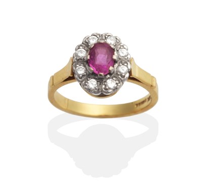 Lot 2070 - An 18 Carat Gold Pink Sapphire and Diamond Cluster Ring, an oval cut pink sapphire within a...