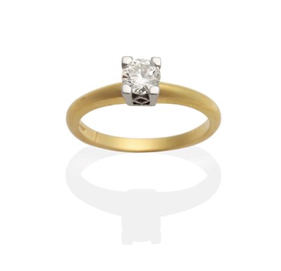 Lot 2075 - An 18 Carat Gold Diamond Solitaire Ring, a round brilliant cut diamond in a claw setting, estimated