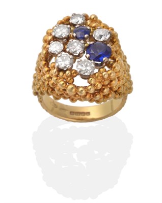 Lot 2078 - An 18 Carat Gold Diamond and Sapphire Ring, round brilliant cut diamonds and two round cut...