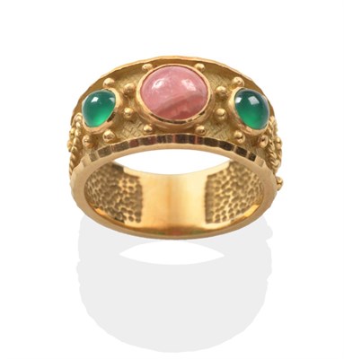 Lot 2082 - A Rhodochrosite and Emerald Ring, a round cabochon rhodochrosite between two round cabochon...