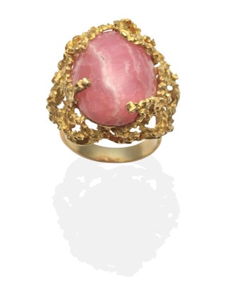 Lot 2084 - A Rhodochrosite Statement Ring, an oval cabochon rhodochrosite in a textured setting, finger...