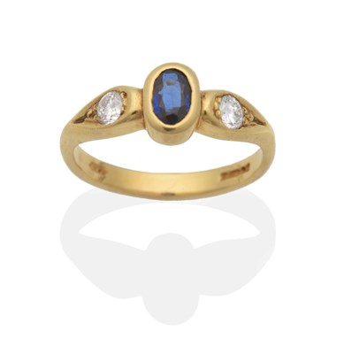 Lot 2093 - An 18 Carat Gold Sapphire and Diamond Three Stone Ring, an oval cut sapphire in a rubbed over...