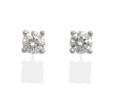 Lot 2107 - A Pair of 18 Carat White Gold Diamond Solitaire Earrings, a round brilliant cut diamond in a...