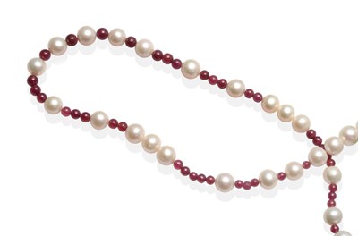 Lot 2109 - A Ruby and Cultured Pearl Necklace, groups of graduated round ruby beads spaced by cultured pearls