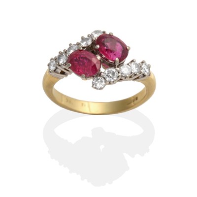 Lot 2110 - An 18 Carat Gold Ruby and Diamond Crossover Ring, two oval cut rubies in claw settings to shoulders