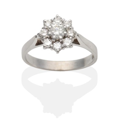 Lot 2113 - An 18 Carat White Gold Diamond Cluster Ring, a round brilliant cut diamond within a border of...