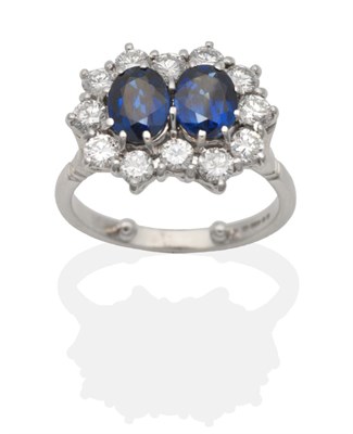 Lot 2115 - An 18 Carat White Gold Sapphire and Diamond Double Cluster Ring, two oval cut sapphires within...