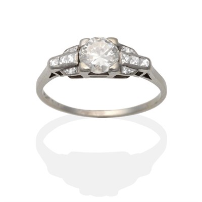 Lot 2117 - A Diamond Solitaire Ring, an old cut diamond in a claw setting between rose cut diamond set stepped