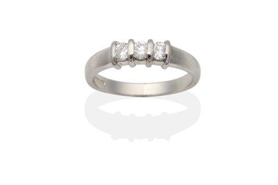 Lot 2128 - An 18 Carat White Gold Diamond Three Stone Ring, round brilliant cut diamonds in bar settings,...