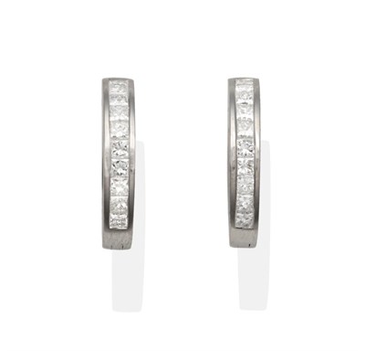 Lot 2129 - A Pair of 18 Carat White Gold Diamond Cuff Earrings, channel set princess cut diamonds to a...