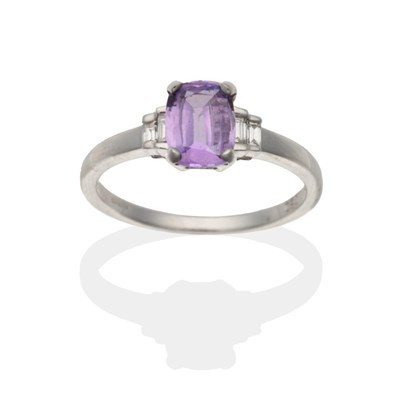 Lot 2136 - An 18 Carat White Gold Purple Sapphire and Diamond Ring, an oval cut purple sapphire in a claw...