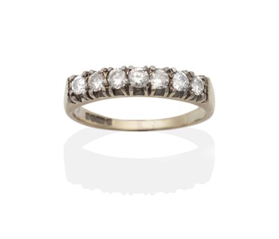 Lot 2139 - An 18 Carat White Gold Diamond Half Hoop Ring, seven round brilliant cut diamonds in claw...